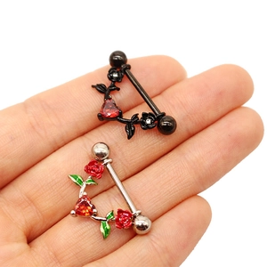 Macro detail of heart-shaped nipple shield rings with rose accents in red and black