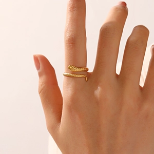Minimalist snake-shaped 18K gold plated stainless steel ring shown on model finger