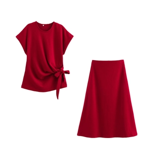 Detail of red crew neck top with side-knot design and A-line midi skirt set