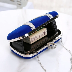 Detail view of royal blue velvet evening clutch bag showing internal storage for phone