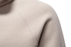 Macro shot of light beige ribbed knit texture and stitching details on a men's sweatshirt