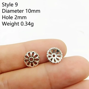 Macro detail of 10mm silver hollow flower spacer beads for DIY jewelry making