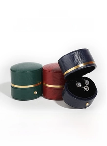 Macro detail of PU leather jewelry boxes with gold trim and crystal snap closures