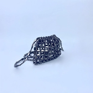 Detailed close-up of handmade gunmetal metallic sequin beadwork and ring link texture