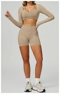 Detail of light khaki ribbed yoga set featuring long sleeve shrug and high waist shorts