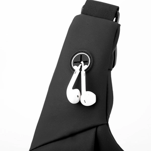 Detail of waterproof nylon chest bag with a silicone headphone port and white earphones