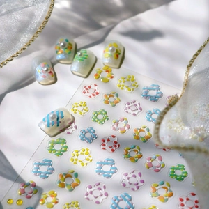 Colorful 3D flower nail art stickers with checkered patterns on clear decals