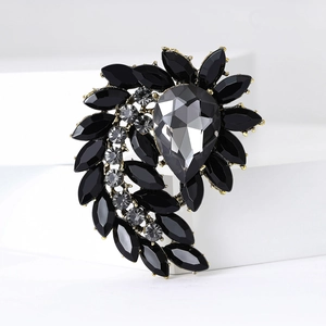 Detail of vintage brooch with black marquise stones and gray teardrop crystal