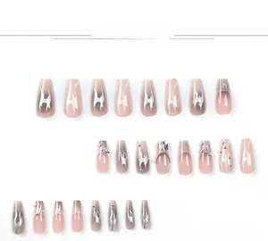 Close-up of long coffin fake nails with pink base, silver flame patterns and rhinestones