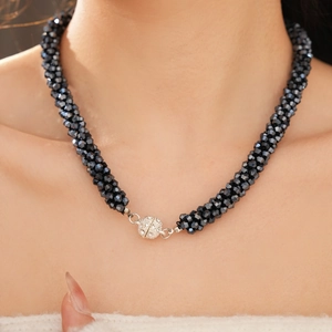 Detail of faceted black glass bead necklace with a silver pavé diamond magnetic clasp