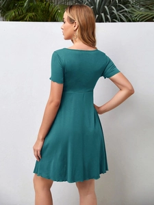 Rear view detail of dark green short sleeve maternity dress with high waist design