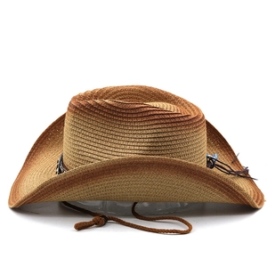 Close-up of woven straw cowboy hat with adjustable chin strap and beaded tassel detail