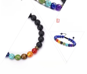 Detail of a handmade seven chakra braided bracelet with natural volcanic lava stone beads