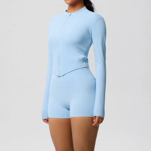 Detail of high-stretch baby blue yoga set with zipper top and high-waist biker shorts
