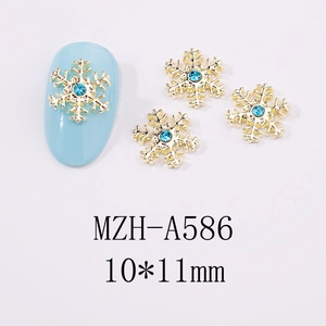 Bijou d'ongle flocon de neige doré avec strass bleu pour manucure hivernale