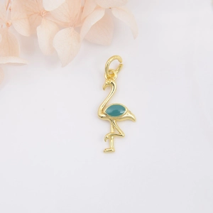 Macro detail of a 18k gold-plated flamingo pendant with blue enamel and floral accents