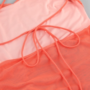 Detail of pink and orange mesh dress showing backless tie design and fabric texture