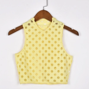 Detail view of yellow laser-cut hollow tank top with intricate pattern texture