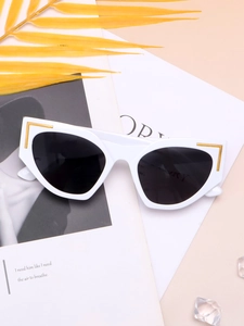 Detailed close-up of white cat-eye sunglasses with elegant gold L-shape metal accents