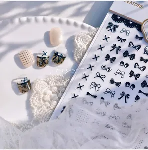 Detail of black and white bow nail art stickers with lace and polka dot patterns