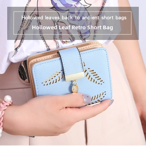 Detail of light blue PU leather wallet featuring hollow leaf pattern and metal pendant