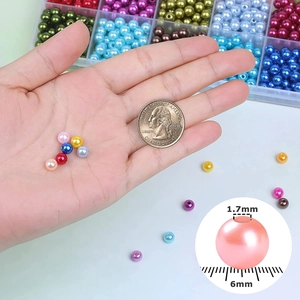 6mm colorful ABS faux pearls set with 1.7mm hole size shown with a coin for scale