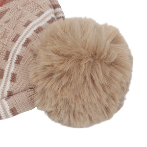 Detailed macro view of plush faux fur pom-pom and knitted geometric patterns on kid's hat