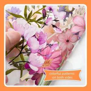 Close-up showing a hand peeling a double-sided floral sticker with colorful patterns