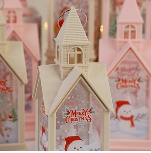 Detail view of a white Christmas lantern featuring snowman and reindeer painted motifs