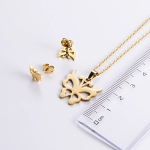 Detailed view of golden butterfly necklace and earrings set with size reference scale