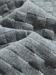 Macro shot of grey textured jacquard fabric with detailed square pattern on casual shirt