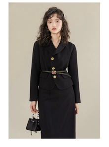 Detail of genuine leather skinny belt with golden flower buckle on a black suit outfit