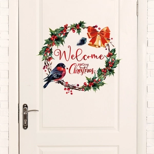 Christmas wreath wall sticker with holly, berries and welcome message on a white door