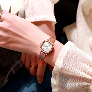 Elegant rose gold square watch for women with white dial and mesh strap on wrist