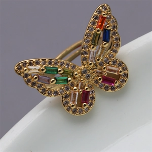 Macro view of butterfly ring with colorful cubic zirconia stones and gold finish