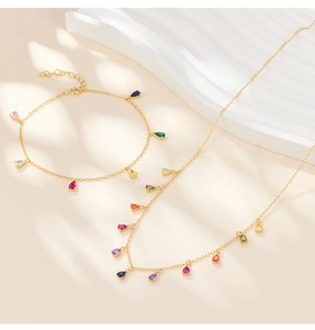 Detail of gold multi-colored pear-cut gemstone necklace set with soft tree shadow