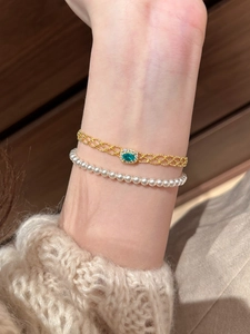 Detail of French vintage square zircon layered bracelet with green emerald and pearls