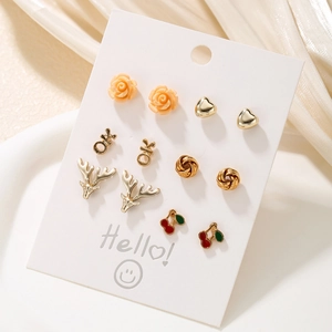 Set of 6 pairs of gold-plated stud earrings featuring floral, heart, and animal designs