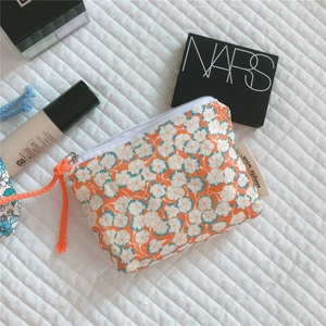 Floral cotton mini storage pouch with zipper and simple wish label on quilted fabric