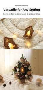Close-up of a glowing wooden Christmas house ornament with warm LED light and hemp rope