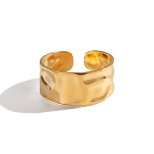 Detail showing irregular hammered texture on a wide golden adjustable metal ring
