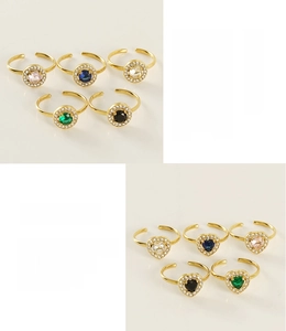 Detail of 18K gold plated stainless steel rings with colorful heart and round crystals