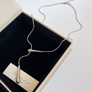 Silver Y-shape waterdrop pendant necklace on black velvet display box for women
