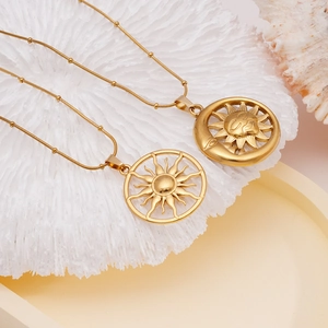 18K gold plated stainless steel sun and moon pendant necklaces on decorative coral stand
