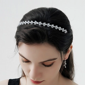 Detailed close-up of silver leaf tiara headband with crystals for bridal wedding look