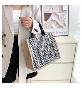 Close-up of geometric zigzag weave pattern and natural jute fabric on large tote bag