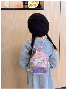 Detailed back view of a pink sequin princess backpack with 3D ears on a young girl