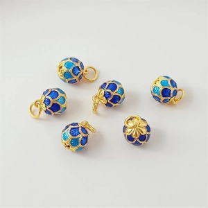 Detailed close-up of 6 blue cloisonne beads with golden fish scale patterns and rings