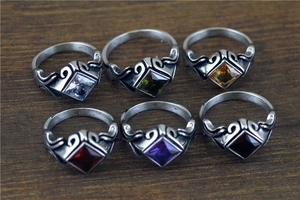Detailed view of vintage rhombic rings set with colorful gemstones in various shades
