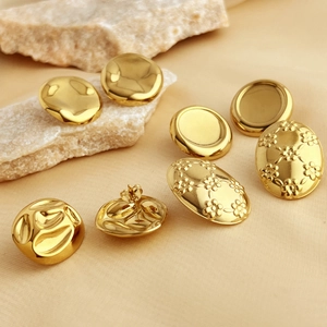 Three pairs of vintage gold oval earrings with hammered and embossed floral textures